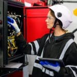 young technician checking and repairing part of a machinery